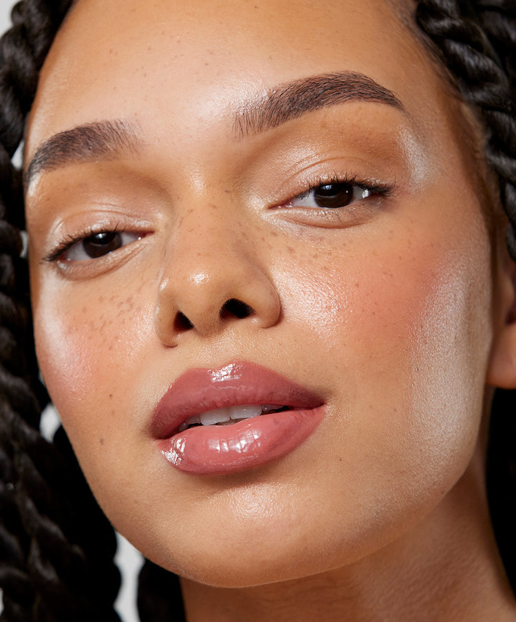 Model wears Lip Sculpt & Lip Gloss in Rosewood